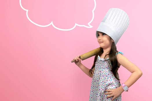 Asian cute girl in chef uniform with copyspace over pink background