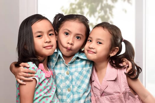 Image of funny asian kids playing on the living room at home