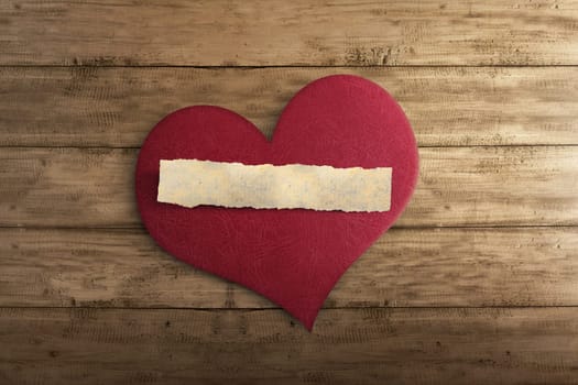 Blank ripped paper on red heart shape with timber background
