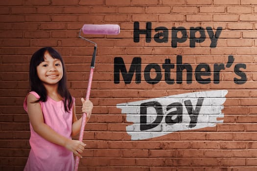 Asian cute girl with pink roller brush paint Happy Mothers day message on brick wall