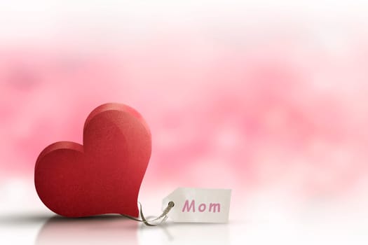 Red heart with Mothers day message over blurred background