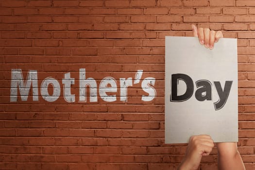 People hand holding white paper to make greeting Mothers day on the wall