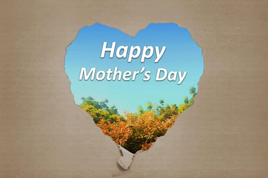 Happy Mothers Day greetings from ripped carton written against natural background