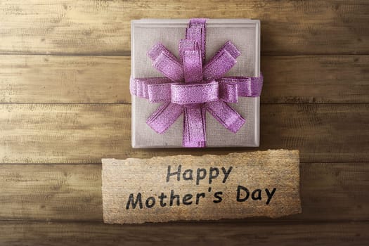 Box gift and Happy Mother's Day message for Mother's day on wooden floor
