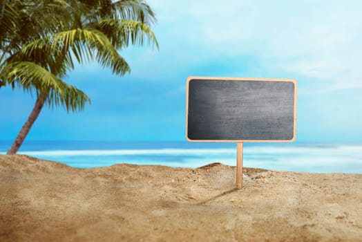 Blank wooden sign on sand at the beach