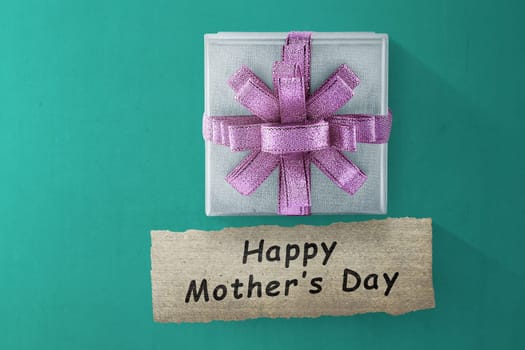 Box gift and Happy Mother's Day message for Mother's day on green floor