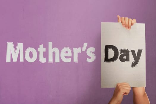 People hand holding white paper to make greeting Mothers day on the pink wall
