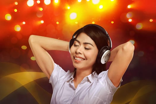 Young asian woman enjoying the music with headphone on blurred background