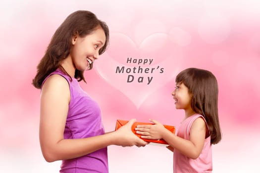Portrait of happy little girl giving gift to her mother. Mothers day concept.