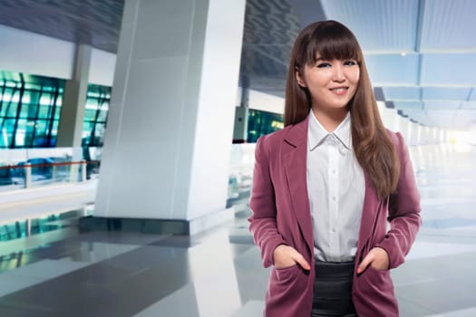 Beautiful asian business woman with hand on the pocket standing in the airport