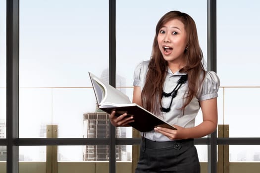 Asian business woman with surprised face expression in the office