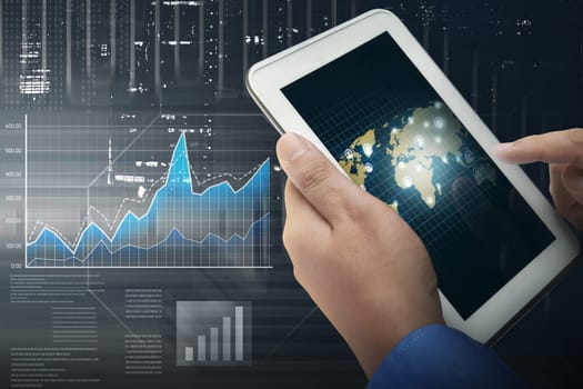 Businessman working with digital tablet with digital financial chart on background