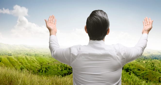 Rear view of asian muslim man praying to god at outdoor