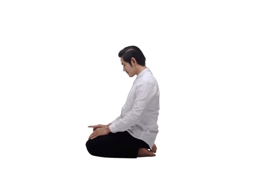 Portrait of asian muslim man praying to god isolated over white background