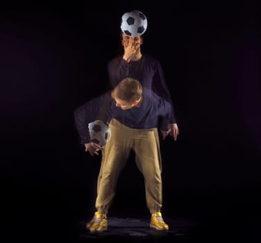 A portrait of a fan with ball on gray studio background. Freestile concept. Stroboscope shooting technique