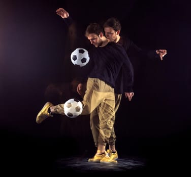 A portrait of a fan with ball on gray studio background. Freestile concept. Stroboscope shooting technique