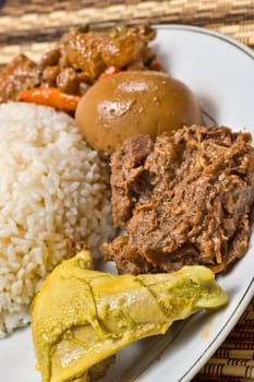 Gudeg is indonesian especially javanese food that served chicken cook with coconut milk. Served with egg, chili.