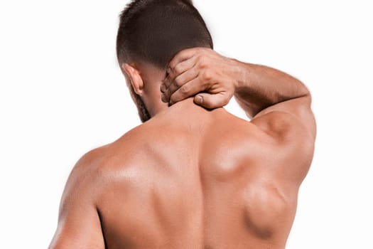 Studio shot of sportsman with pain in neck