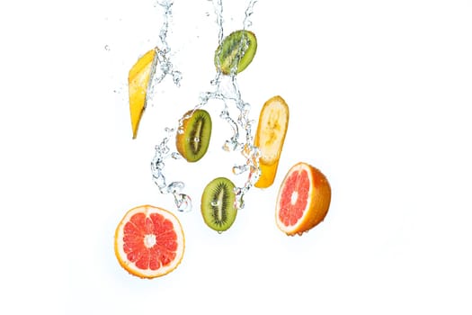 The fresh fruits falling with water splash, isolated on white background