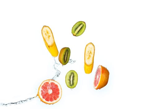 The fresh fruits falling with water splash, isolated on white background