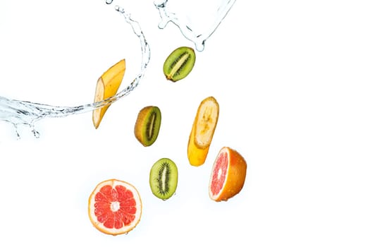 The fresh fruits falling with water splash, isolated on white background