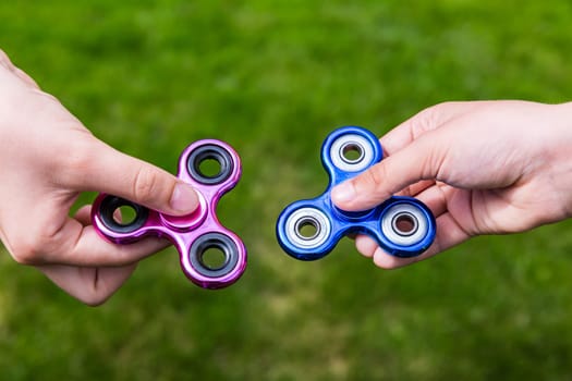 Kid hands with popular toy fidget spinners