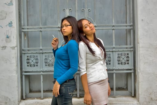 Two Young Asian Girl at Outdoor wearing white suit and blue shirt