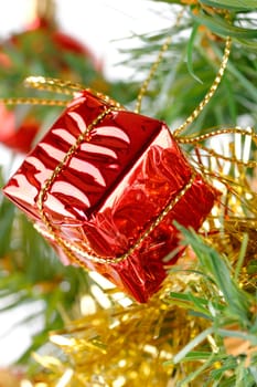 Christmas gift box hanging on tree over white background