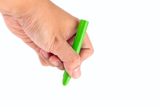Hand holds green crayon. Ready to draw