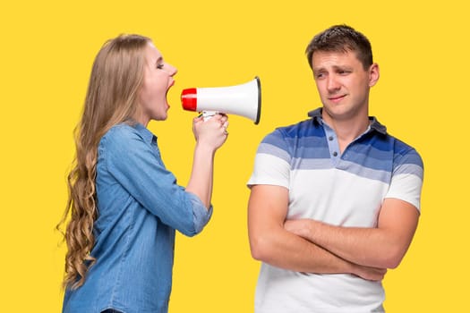 Woman shouting in megaphones with woman at each other