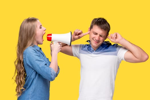 Woman shouting in megaphones with woman at each other
