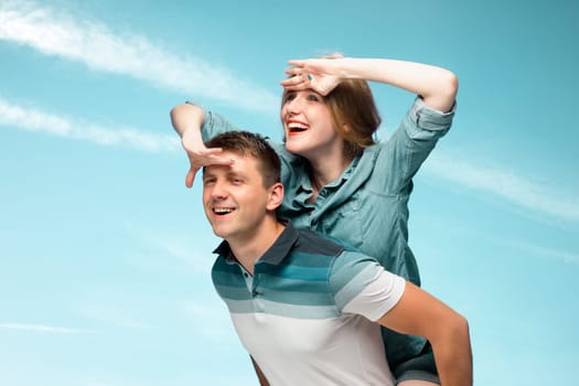 Young love Couple smiling under blue sky and looking away