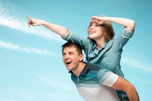 Young love Couple smiling under blue sky and looking away