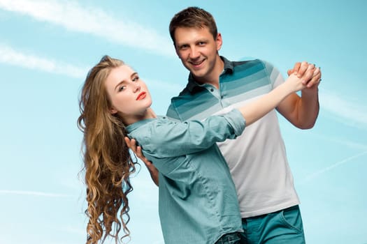 Young happy love Couple smiling under blue sky