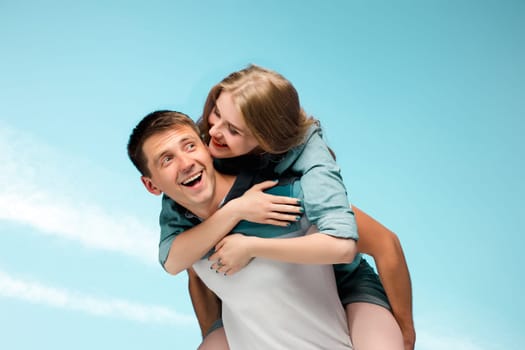 Young happy love Couple smiling under blue sky