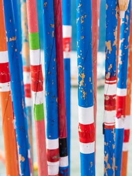 Close-up on bunch of colourful traditional bamboo fishing rods