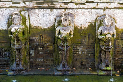 Bali, Indonesia - May 1, 2017 : Bathing Temple Figures at the Goa Gajah Elephant Cave Temple near Ubud, Bali, Indonesia