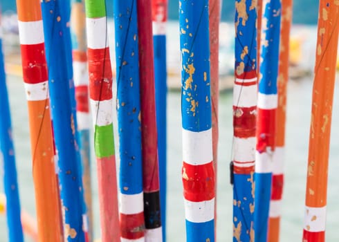 Close-up on bunch of colourful traditional bamboo fishing rods