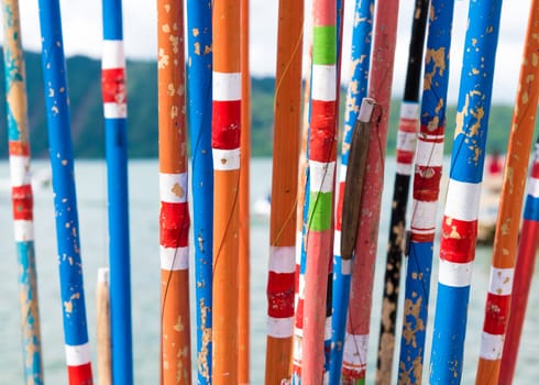 Close-up on bunch of colourful traditional bamboo fishing rods