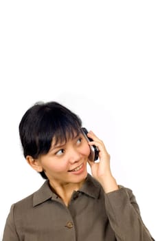Pretty Asian Woman, text on her cellpone with happy face. There is empty space for advertisement