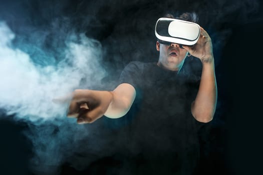 The man with glasses of virtual reality. Future technology concept. Black studio smoky background