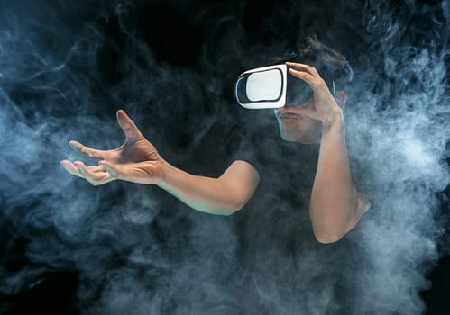 The man with glasses of virtual reality. Future technology concept. Black studio smoky background