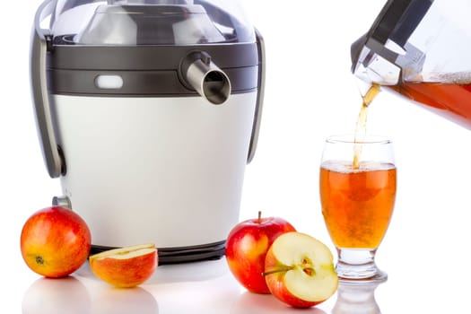 Juicer and apple juice preparing healthy fresh juice on white background.