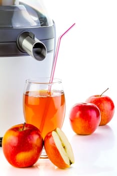 Juicer and apple juice preparing healthy fresh juice on white background.