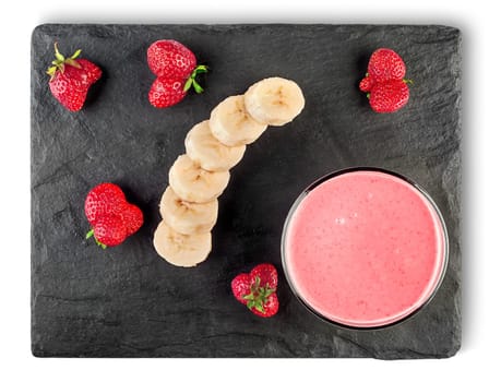 Banana strawberry smoothies with ingredients on black shale stone top view