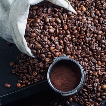 Coffee beans and holder from an espresso machine.