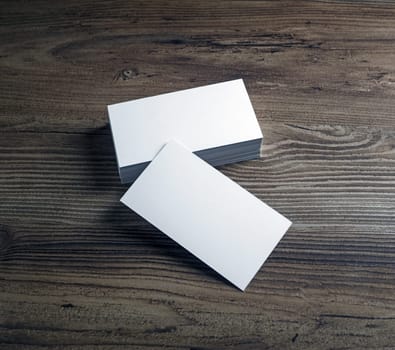 Photo of blank business cards on wooden table background. Presentation template for designers.