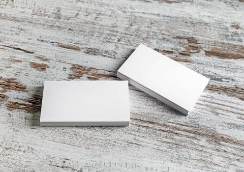 Photo of blank business cards on vintage wood table background. Presentation template for branding identity.