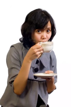 Beautiful Asian Business Woman drink a cup of coffee and sitting at the table