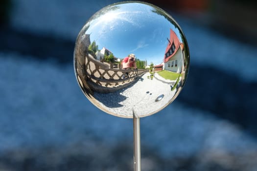 House,fence,photographer and front garden as a reflection in a sphere
